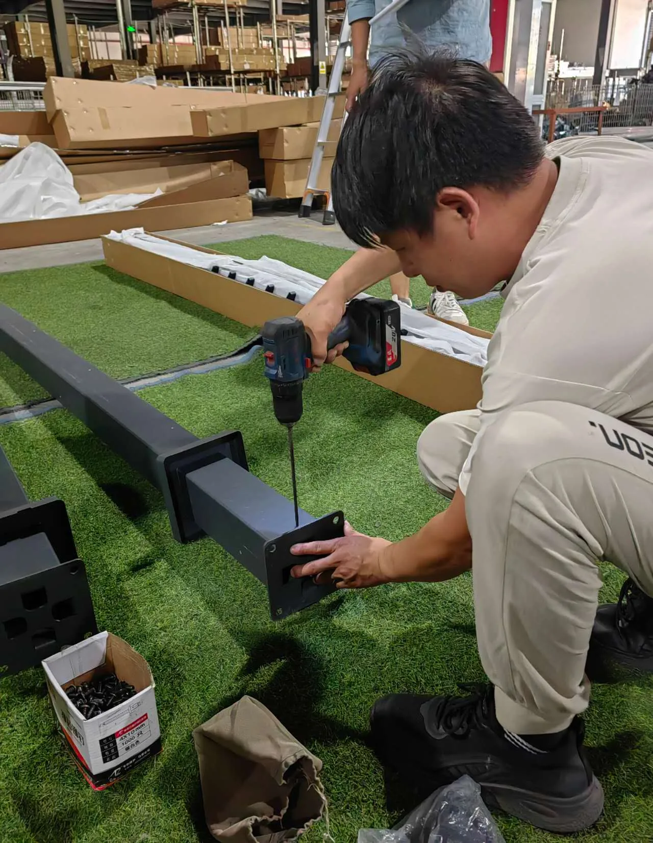 HI-COM project manager reviewing technical documentation on-site with a supplier in China.