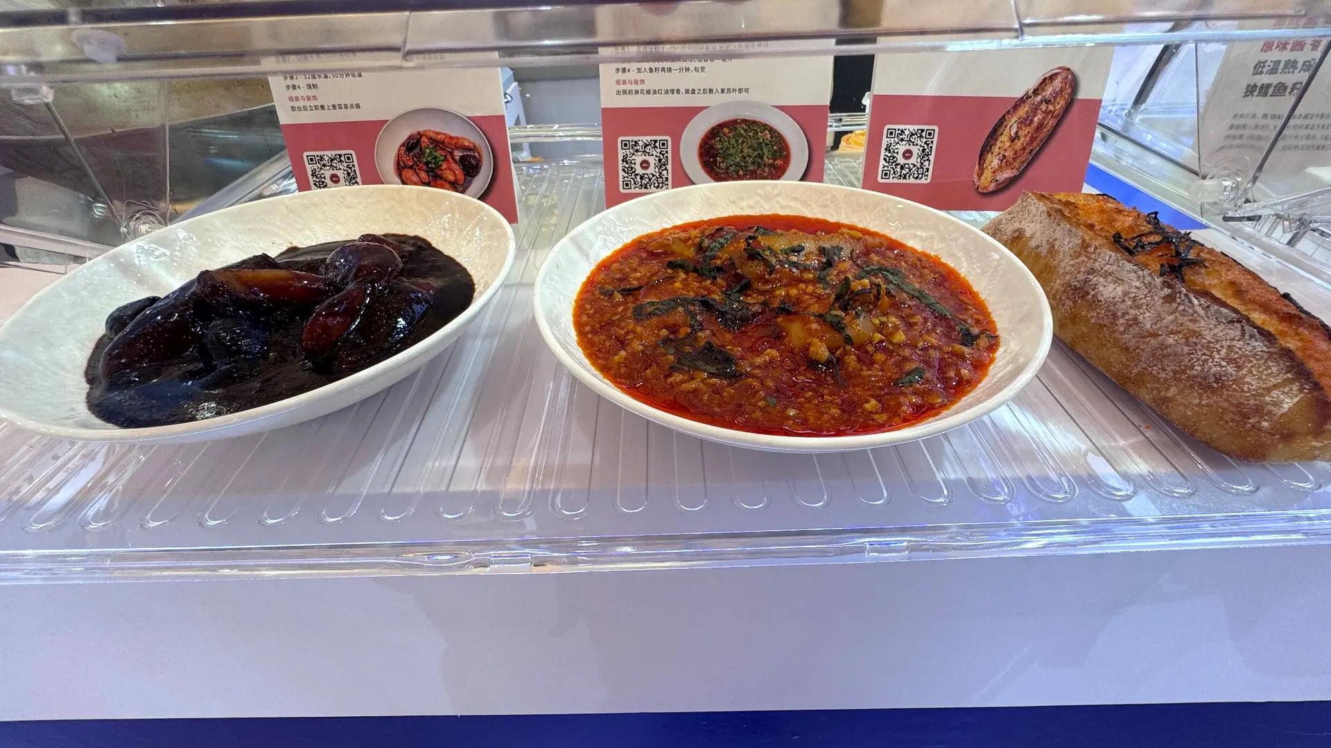 Branded food samples presented in a clear display case during an exhibition activation in China.