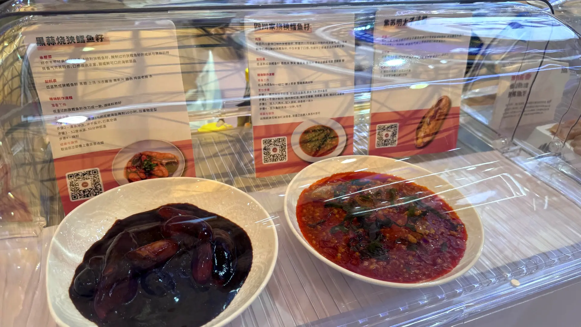 Prepared seafood dishes displayed as part of a culinary product activation at a Shanghai exhibition.