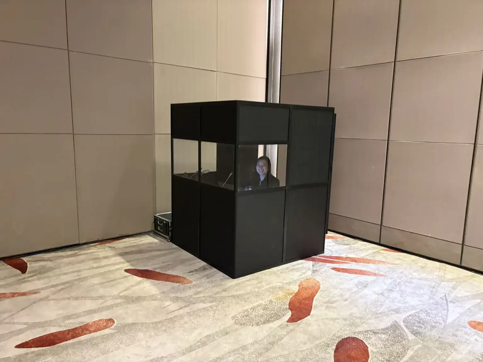 Professional interpreter working inside a simultaneous interpreting booth at the Beijing Energy Briefing