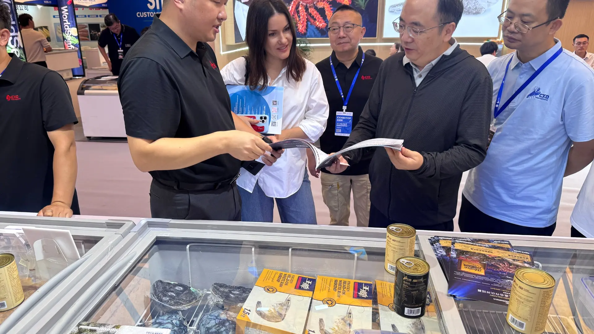 Three seafood tasting samples arranged in a transparent display at a trade exhibition booth.