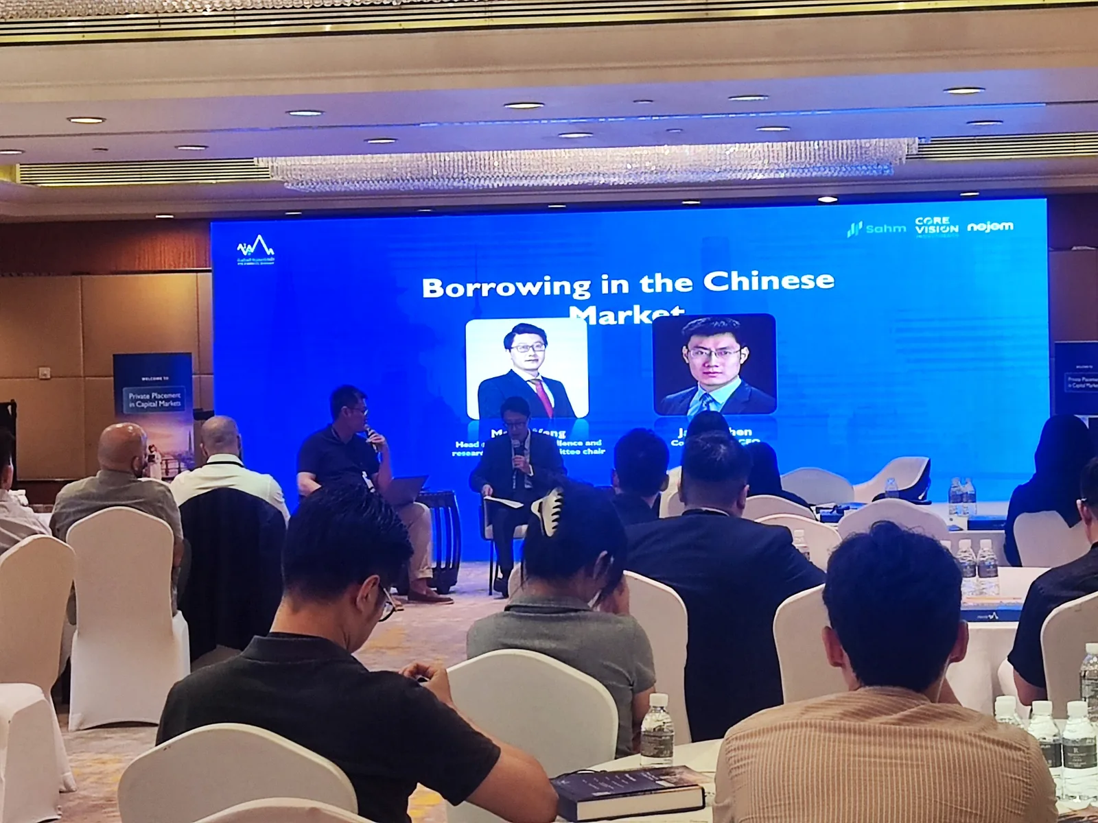 Panel discussion on the Chinese capital market during a finance event in Shanghai with English–Chinese interpreting support.