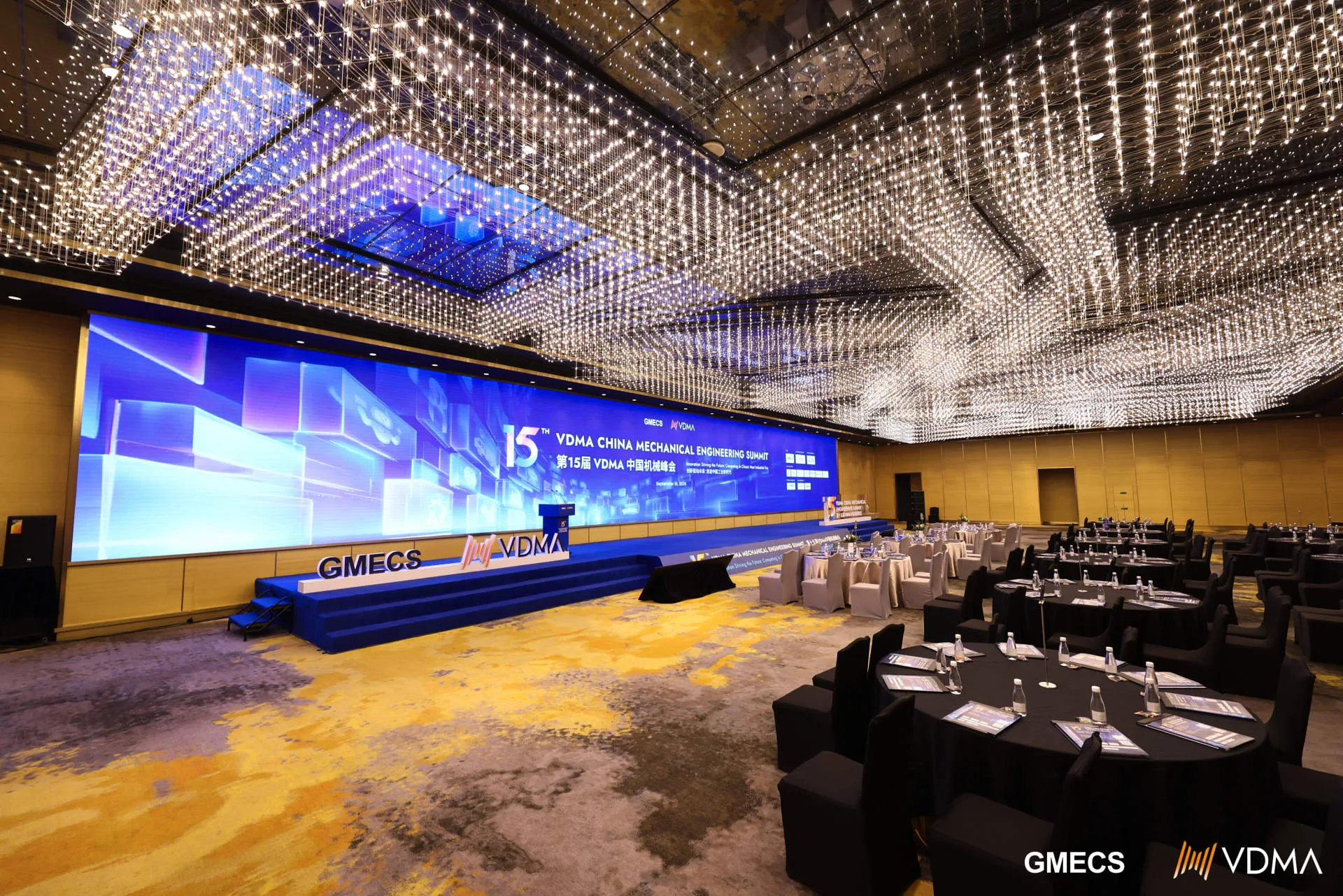 HI-COM technician checking the conference audio and stage setup ahead of the VDMA China Mechanical Engineering Summit.