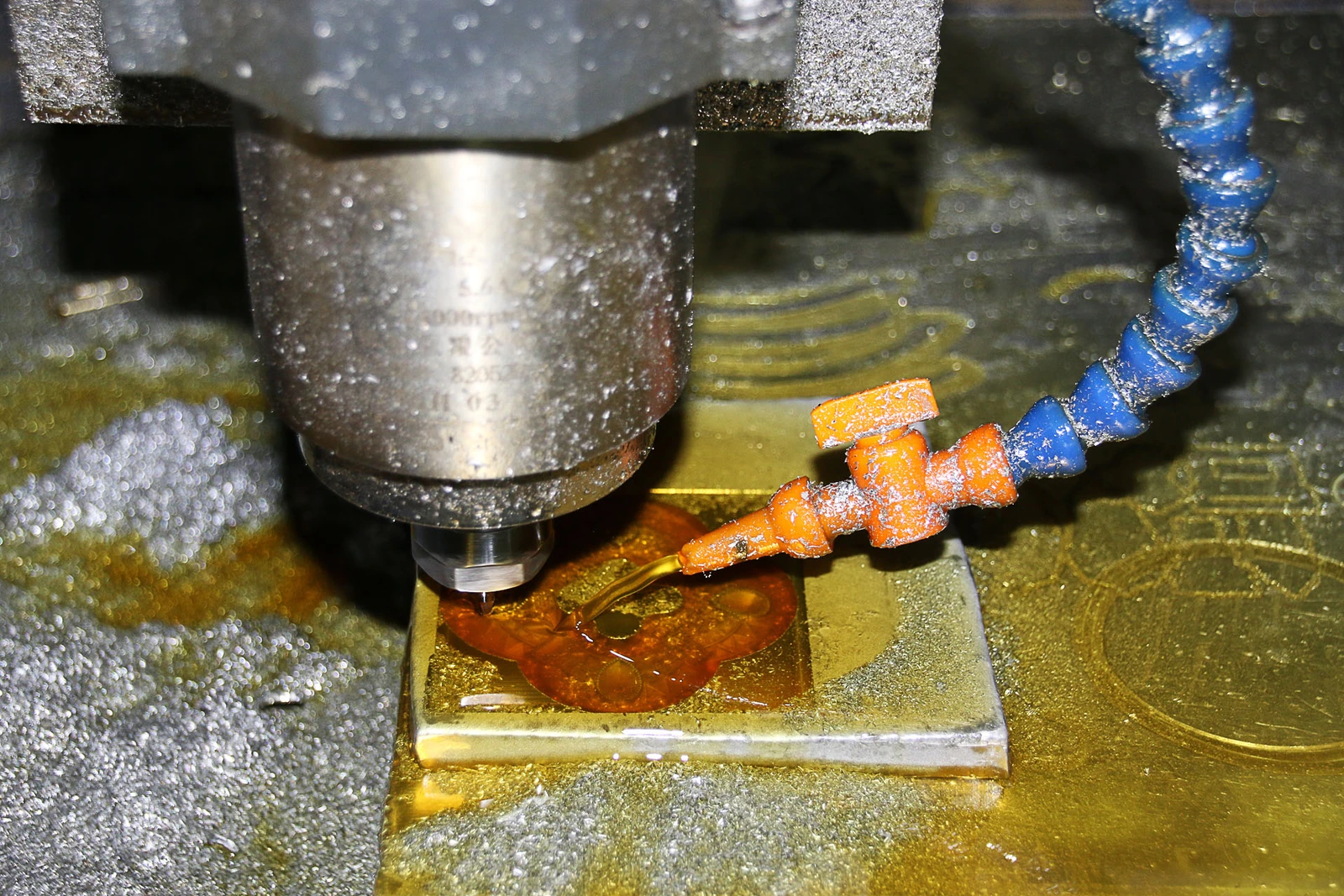 Close-up photograph of a CNC milling cutter machining a metal component with coolant.