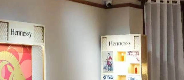 Two illuminated Hennessy display units with artwork and product-history images in the Shanghai event space.