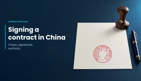 Signing a contract in China: chops, signatures and authority, with a wooden stamp, pen and real company-seal example on a document.